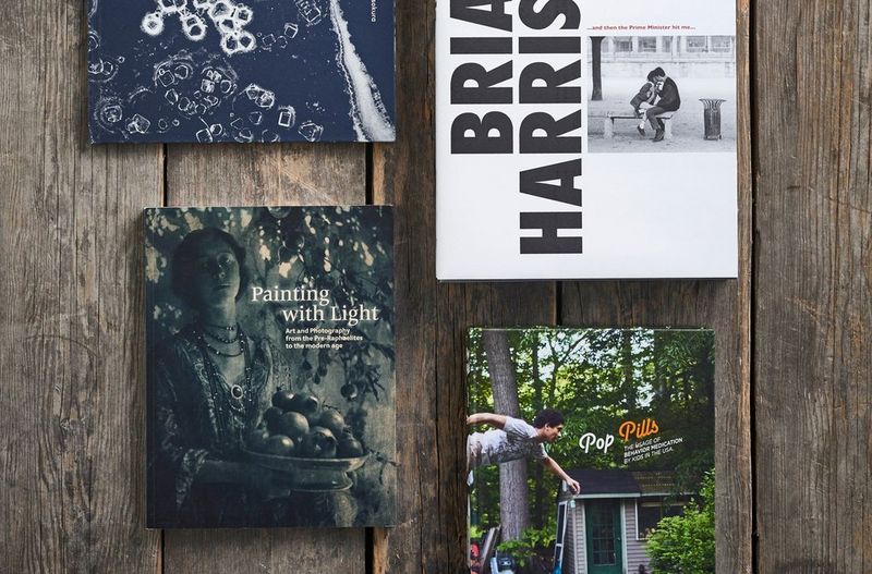 A selection of photography books layed out on a table. 